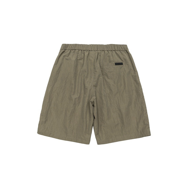 Solid color loose silhouette anti splash water pressure pleated suit shorts for men