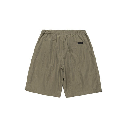 Solid color loose silhouette anti splash water pressure pleated suit shorts for men